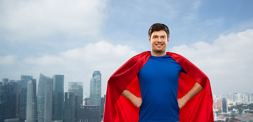 Image showing man in red superhero cape over singapore city