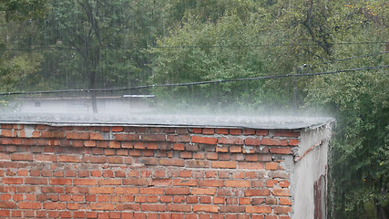 Image showing Rain as downpour on roof of barn in summertime