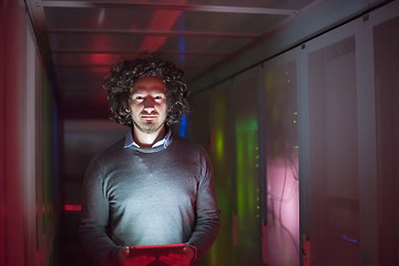 Image showing IT engineer working on a tablet computer in server room