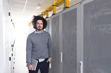 Image showing IT engineer working on a tablet computer in server room