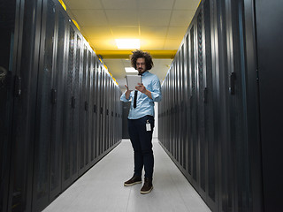 Image showing IT engineer working on a tablet computer in server room