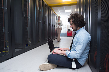 Image showing Team of young technicians working together on servers