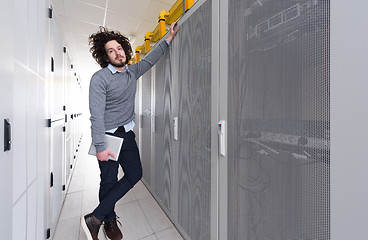 Image showing IT engineer working on a tablet computer in server room