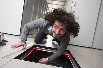 Image showing engineer connecting cables in server room