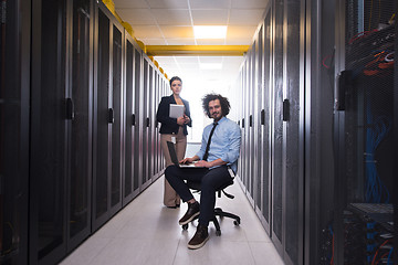 Image showing Team of young technicians working together on servers