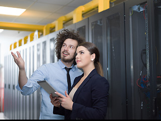 Image showing engineer showing working data center server room to female chief