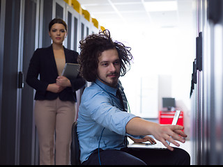 Image showing Team of young technicians working together on servers