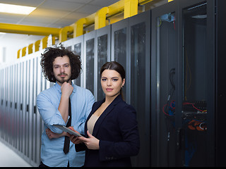 Image showing engineer showing working data center server room to female chief