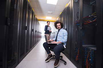 Image showing Team of young technicians working together on servers