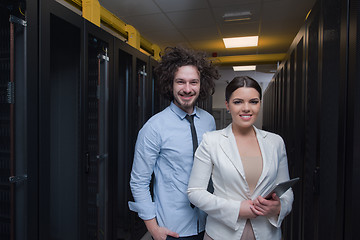 Image showing engineer showing working data center server room to female chief