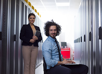 Image showing Team of young technicians working together on servers