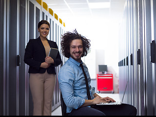 Image showing Team of young technicians working together on servers