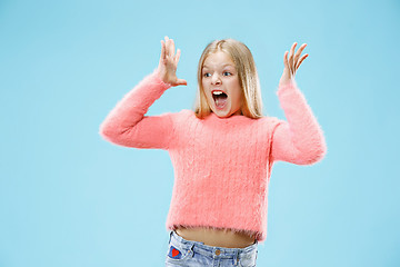 Image showing Isolated on pink young casual teen girl shouting at studio