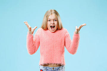 Image showing Isolated on pink young casual teen girl shouting at studio