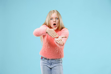 Image showing Beautiful female half-length portrait on studio backgroud. The young emotional teen girl