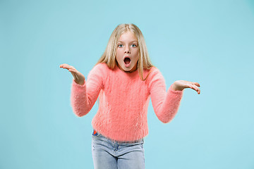 Image showing Beautiful female half-length portrait on studio backgroud. The young emotional teen girl