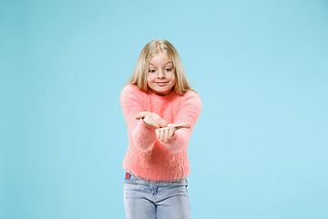 Image showing Beautiful female half-length portrait on studio backgroud. The young emotional teen girl