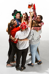 Image showing Football fans hugging with beers on white background