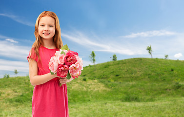 Image showing happy red haired girl with flowers