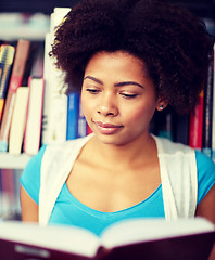 Image showing african student girl reading book at library