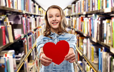 Image showing smiling teenage girl with red heart over library