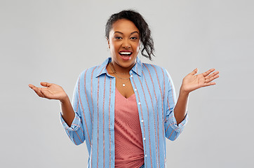 Image showing surprised african american woman shrugging