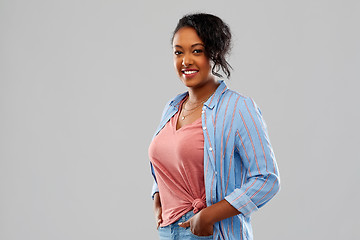 Image showing happy african american woman over grey background