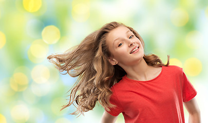 Image showing smiling teenage girl in red with long wavy hair