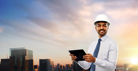 Image showing architect or businessman in helmet with tablet pc