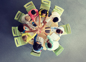 Image showing group of international students with hands on top