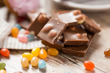 Image showing close up of drop candies and chocolate on table