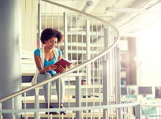 Image showing african student girl reading book at library