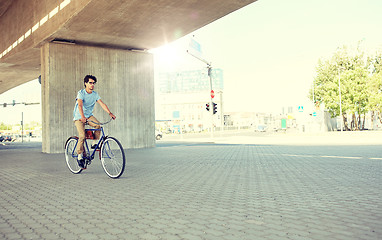 Image showing young hipster man riding fixed gear bike