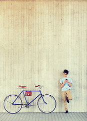 Image showing man with smartphone and fixed gear bike on street