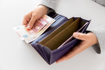 Image showing close up of woman hands with wallet and euro money