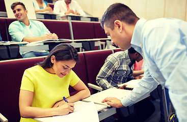 Image showing group of students and teacher with notebook