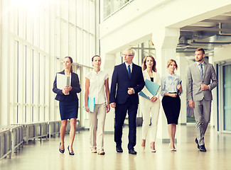 Image showing business people walking along office building