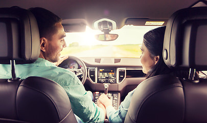 Image showing happy man and woman driving in car