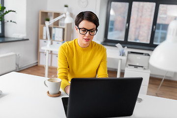 Image showing businesswoman with laptop and coffee at office