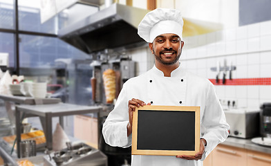 Image showing happy indian chef with chalkboard at kebab shop