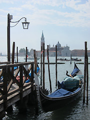 Image showing Old wooden pier with parking italian tradition gondola.