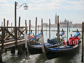 Image showing Traditional italian gondolas parking near berth.