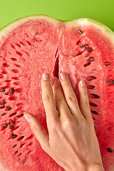 Image showing Simulation of masturbation woman\'s finger inside ripe watermelon.