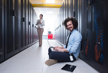 Image showing Team of young technicians working together on servers