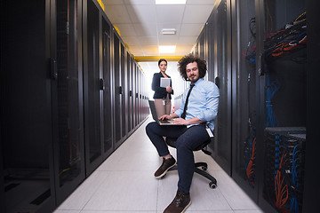 Image showing Team of young technicians working together on servers