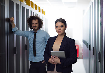 Image showing engineer showing working data center server room to female chief