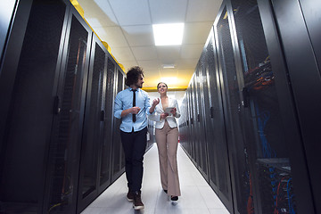 Image showing engineer showing working data center server room to female chief