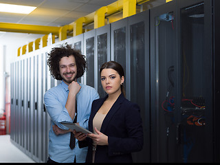 Image showing engineer showing working data center server room to female chief