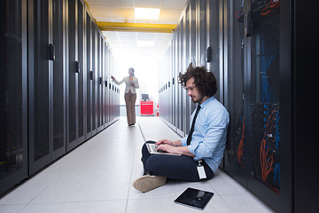 Image showing Team of young technicians working together on servers