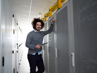 Image showing IT engineer working on a tablet computer in server room